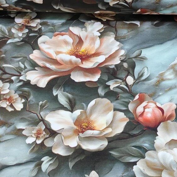 Blush pink magnolia flowers and blossoms print upholstery curtain fabric on a blue greyish marble background.