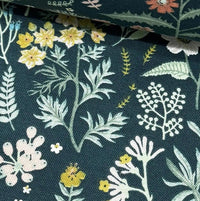 Forest green tapestry upholstery fabric designed with yellow red small flowers and sage green leaves.