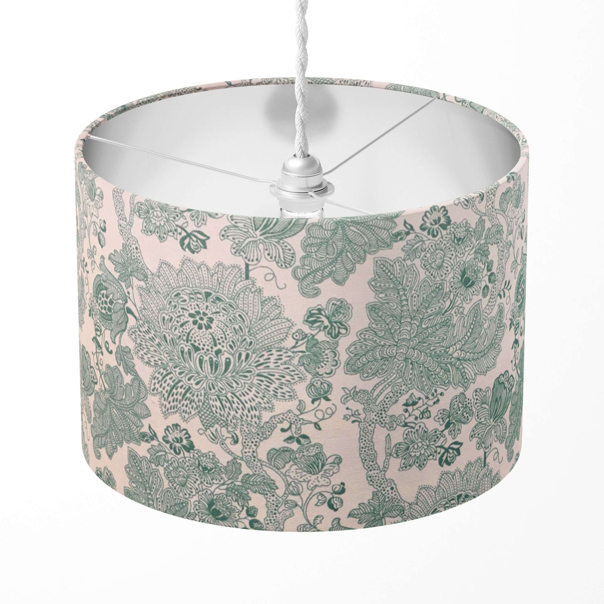 Decorative mint green lampshade with floral pattern on a white background.