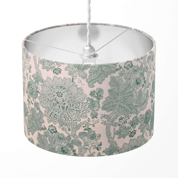 Decorative mint green lampshade with floral pattern on a white background.