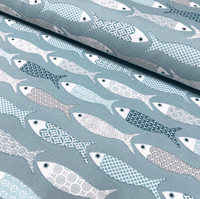 Patchwork design fish print fabric in mint green duck egg and white colours for upholstery curtain making and home decor.