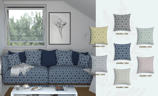 Sofa upholstered with navy white tile pattern fabric and tile patterned cushions in different colours and a window view.