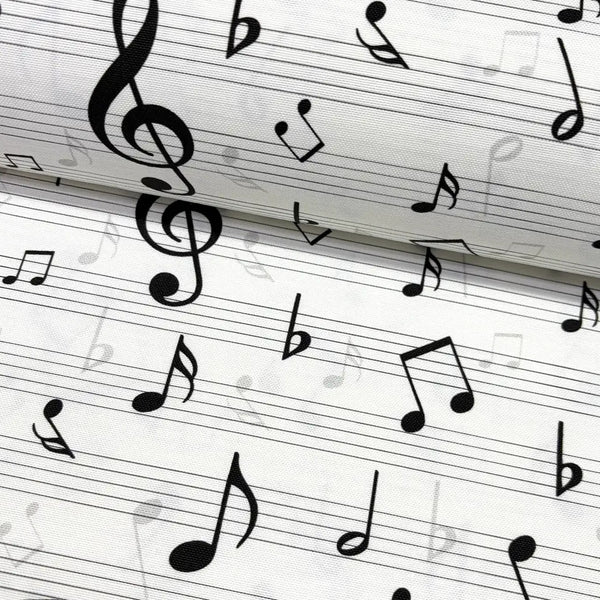 Close-up of black & white music notes patterned upholstery fabric.