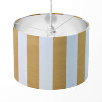 Mustard yellow and white vertical stripe lampshade on a white background.