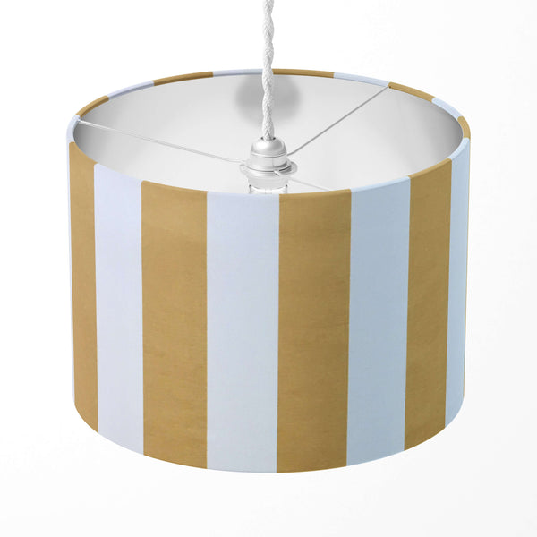 Mustard yellow and white vertical stripe lampshade on a white background.
