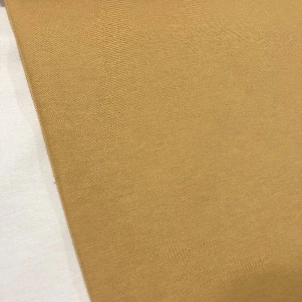 Mustard yellow cotton canvas fabric in a plain ochre yellow shade, suitable for upholstery, curtains, cushions, chairs and home decor.