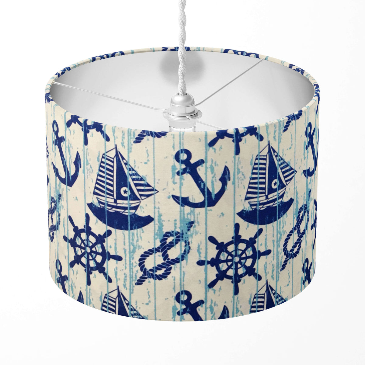 Lampshade with nautical design featuring ships, anchors, and steering wheels on a white background.