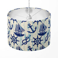 Lampshade with nautical design featuring ships, anchors, and steering wheels on a white background.