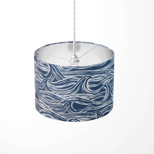 Navy blue nautical ceiling lampshade with white surf pattern.