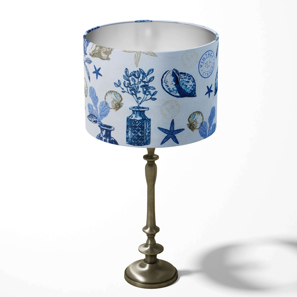 Decorative table lamp shade in blue and white featuring sea-themed beach ocean patterns on a white background.