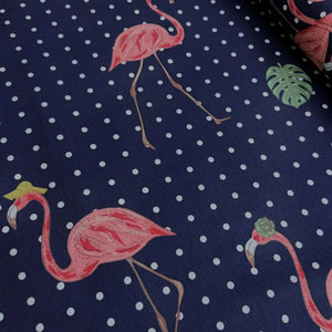 Pink flamingo pattern on a navy blue fabric with white polka dots.