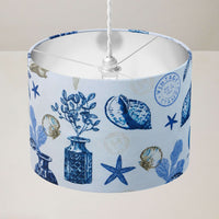Ceiling light shade with blue coastal design on a white background.