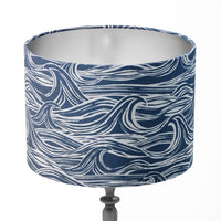 Table lampshade with navy blue and white wave pattern on a white background.