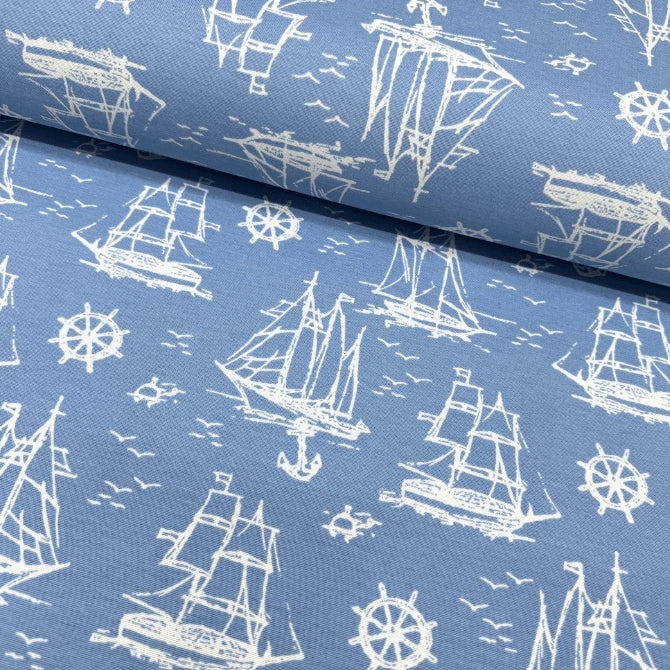 Cotton upholstery fabric with white ship, anchor, birds, sea and wheel pattern on a blue background.