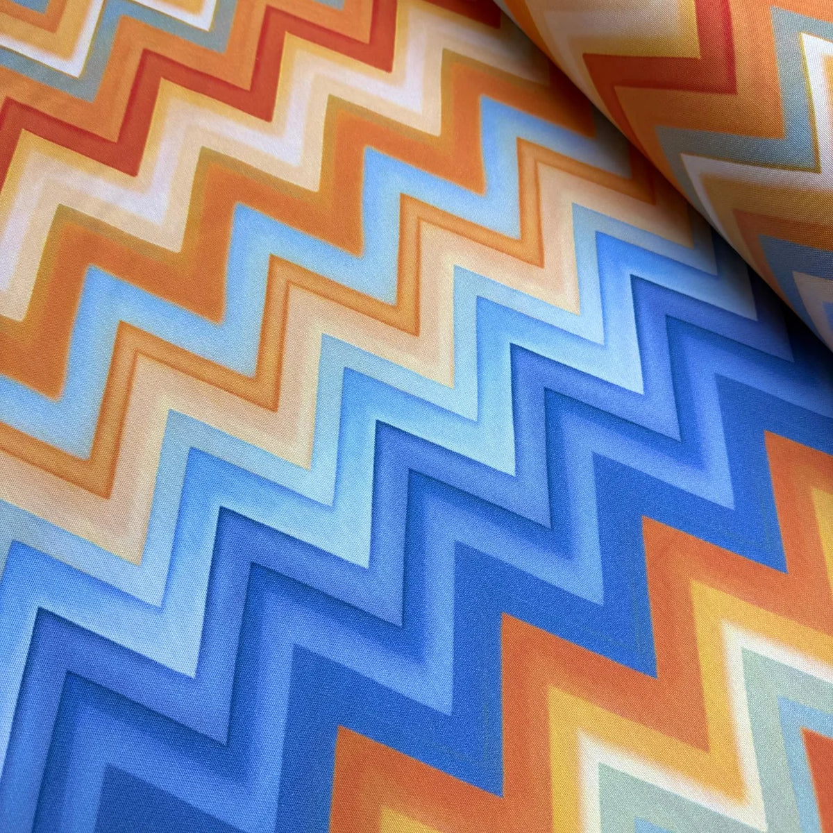 Colorful zigzag pattern fabric with blue, orange, and red colors.