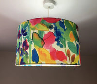 Colorful floral and leaves patterned lampshade on a plain background.
