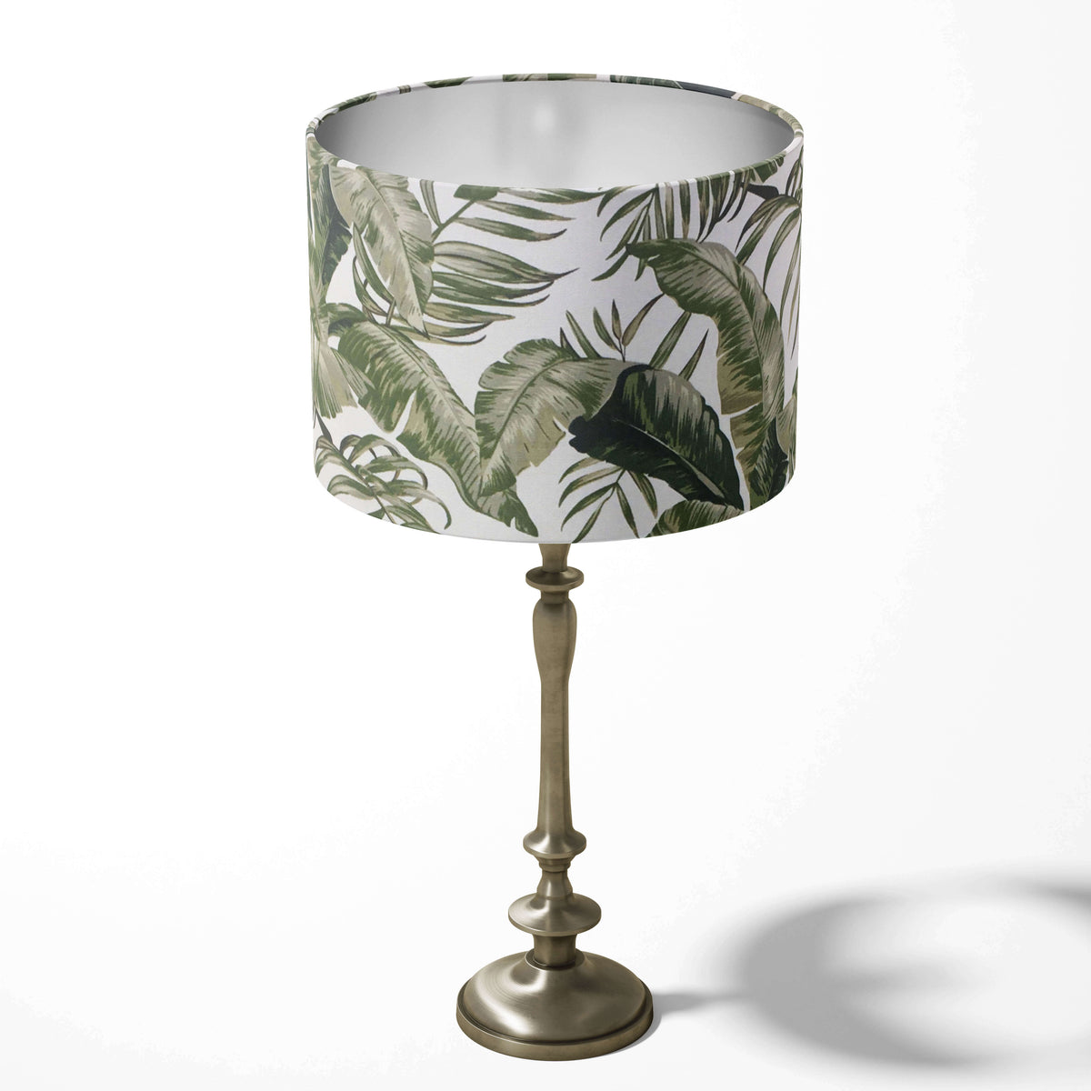 Table drum lampshade with a palm leaf pattern on a white background.