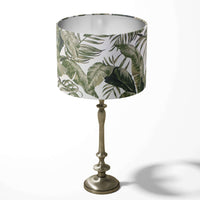 Table drum lampshade with a palm leaf pattern on a white background.