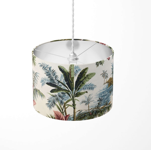 Tropical green palm leaf and tree patterned ceiling lampshade on a white background.