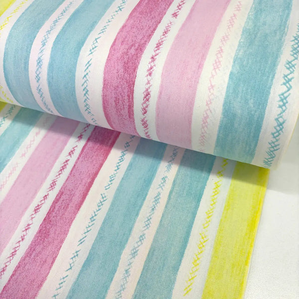 Pastel watercolour stripe cotton poplin fabric featuring pink, blue, and yellow hand-painted stripes on a white background.