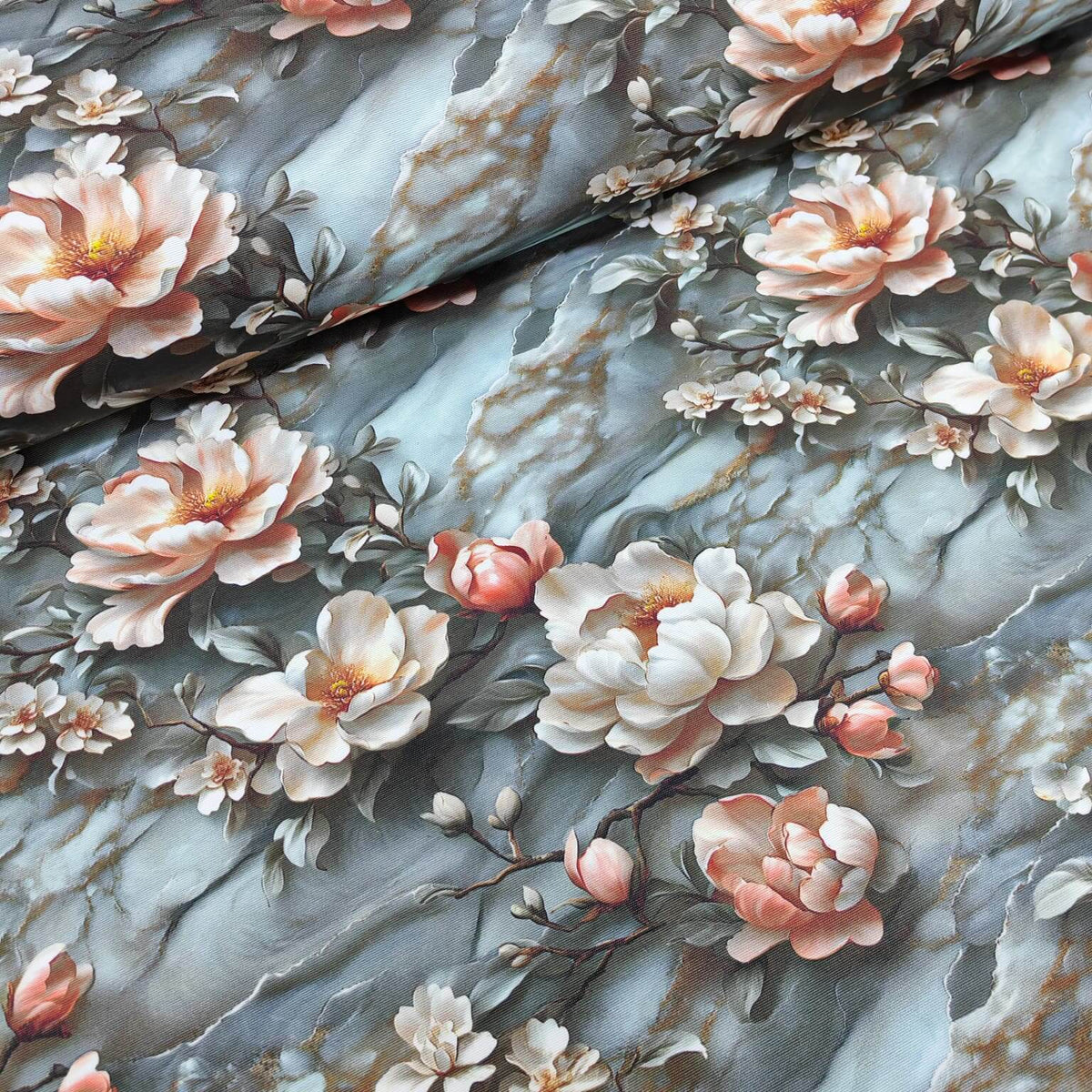 Peach floral upholstery curtain fabric on blue grey marble patterned background.