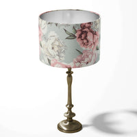 Grey table lampshade with pink and white peony flower pattern on a white background.