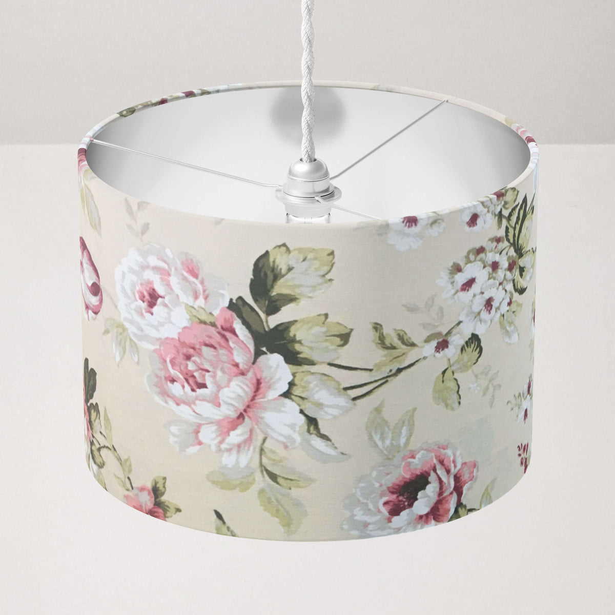 Vintage floral rose patterned beige ceiling lampshade on a plain background.