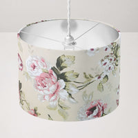 Vintage floral rose patterned beige ceiling lampshade on a plain background.