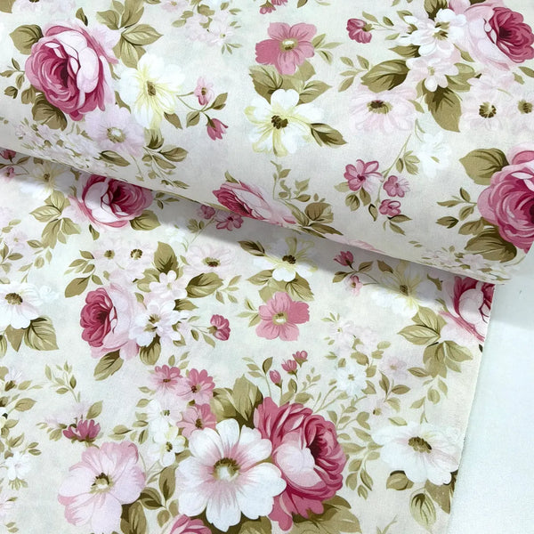 Pink roses cotton poplin fabric featuring vintage floral blooms and green foliage on a cream background.