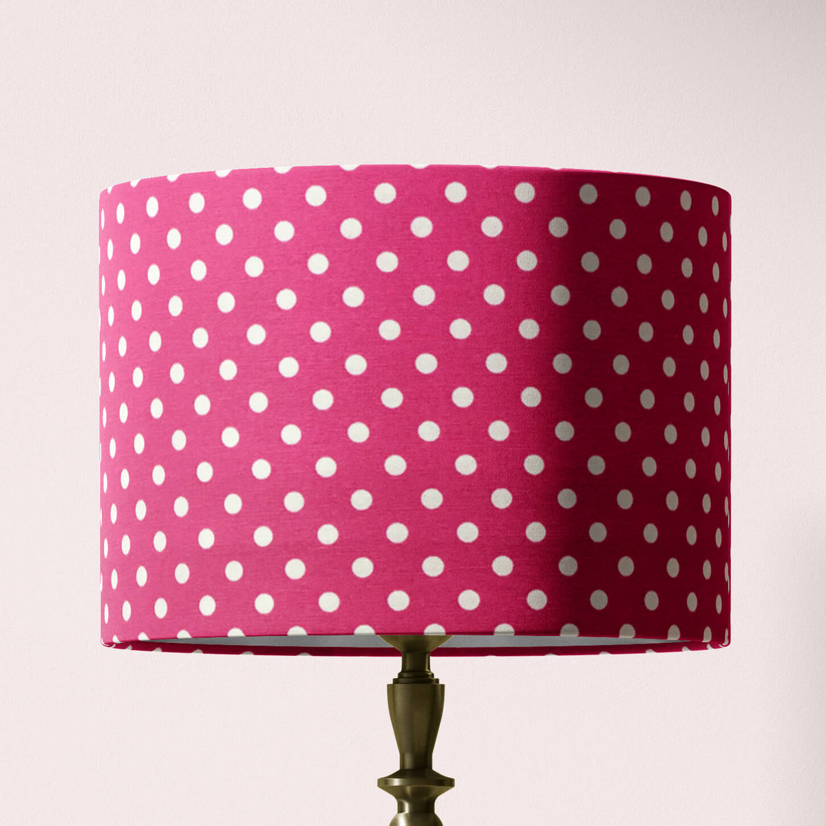 A cerise pink polka dot lampshade designed for table lamps, floor lamps, or ceiling pendants.