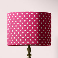 A cerise pink polka dot lampshade designed for table lamps, floor lamps, or ceiling pendants.
