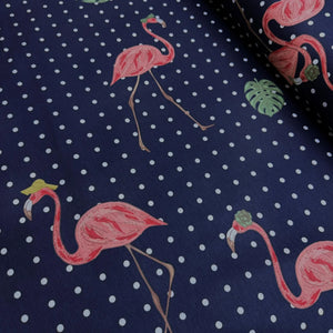 Upholstery & curtain fabric with pink flamingo and polka dot pattern on a navy blue background.