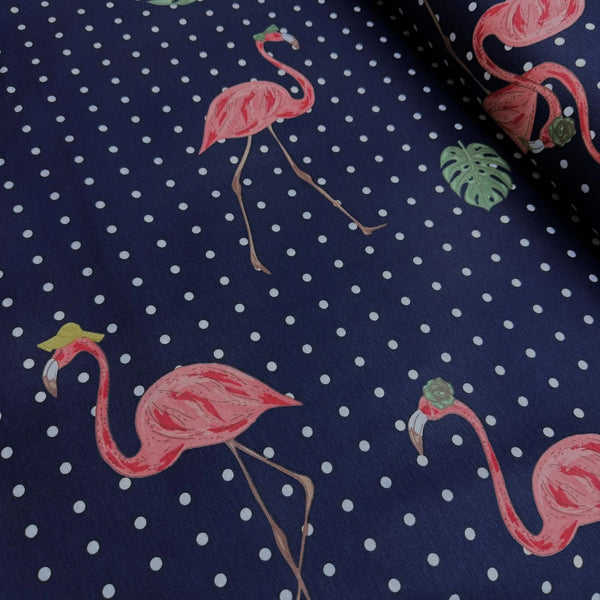 Upholstery & curtain fabric with pink flamingo and polka dot pattern on a navy blue background.