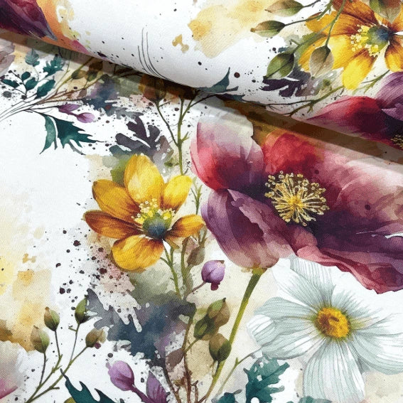 Large print upholstery fabric patterned with red poppies, yellow white daisies, wild flowers and green leaves.