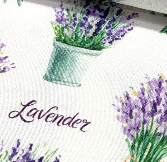 Decorative cotton canvas upholstery fabric with lavender design and text on a white background.