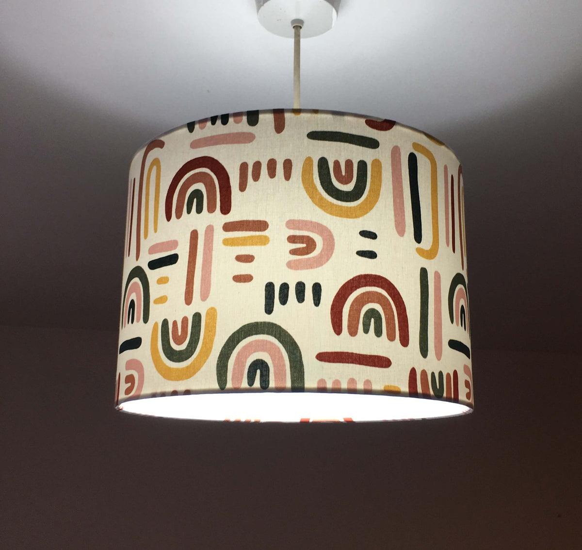 Rainbow patterned drum ceiling light shade.