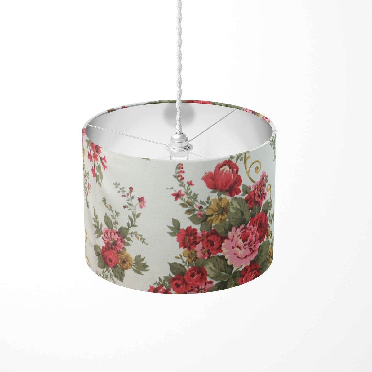 Red roses and flowers and green leaves patterned ceiling lampshade on a white background.