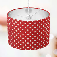 Red lampshade with white polka dots on a blurred background.
