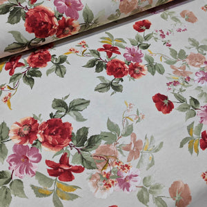 Floral patterned upholstery fabric with red, pink, and green flowers on a cream background.