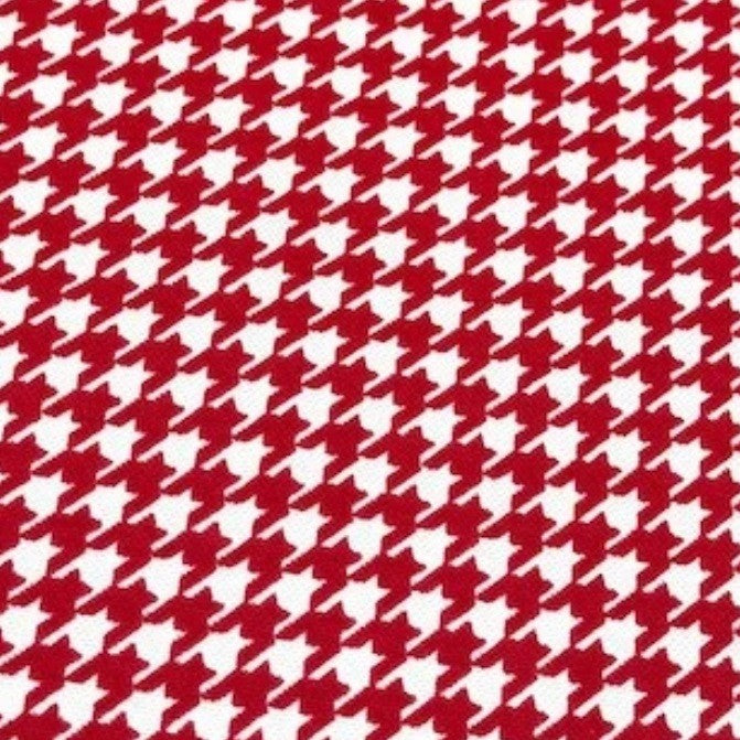 Houndstooth pattern cotton canvas fabric in red and white.