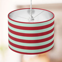 Striped lampshade with red and white horizontal stripes on a blurred background.