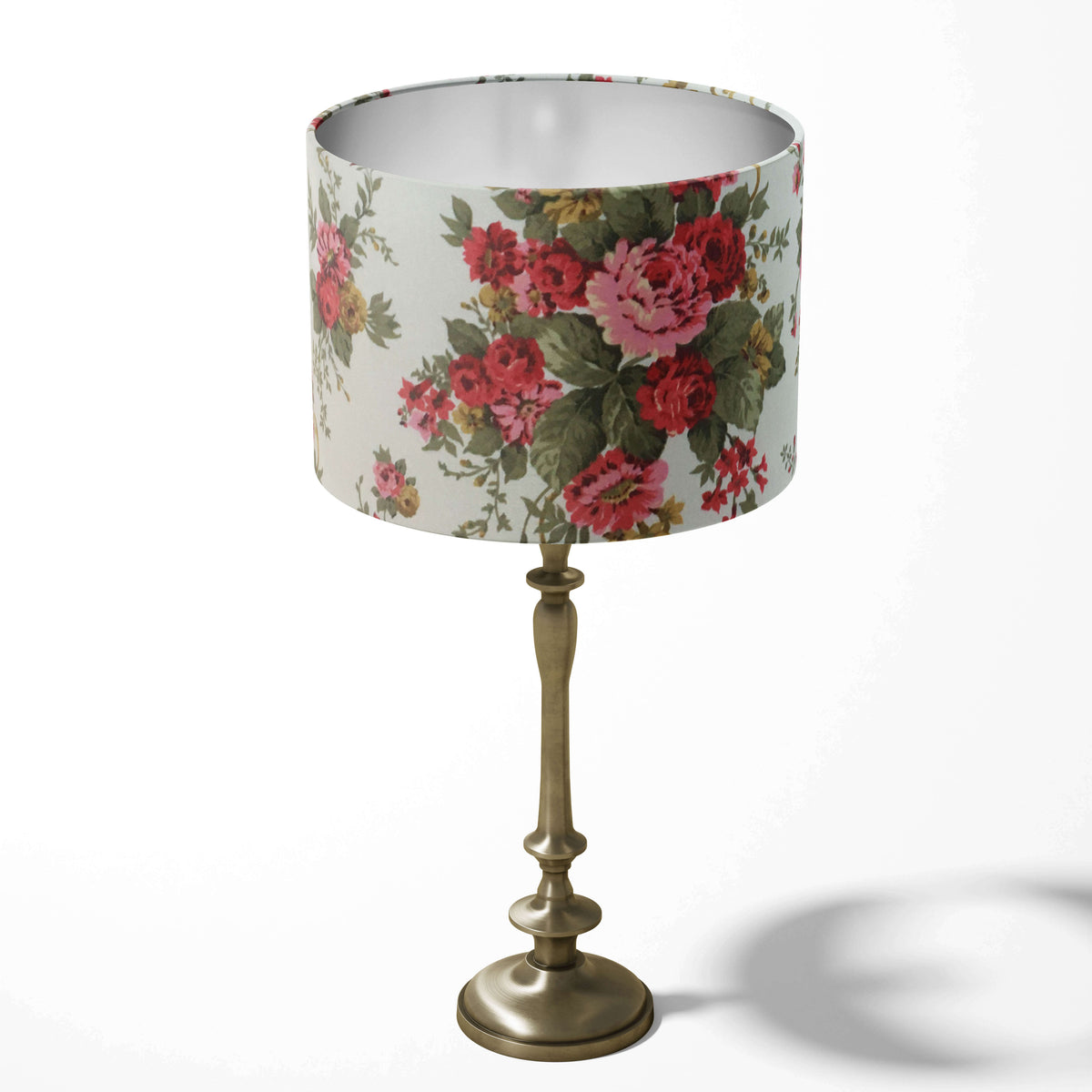 Retro red floral-patterned table lampshade on a white background.