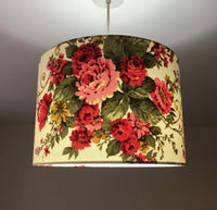 Red floral patterned lampshade on a plain background.