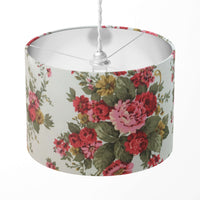 Red roses and green leaves patterned lampshade on a white background.