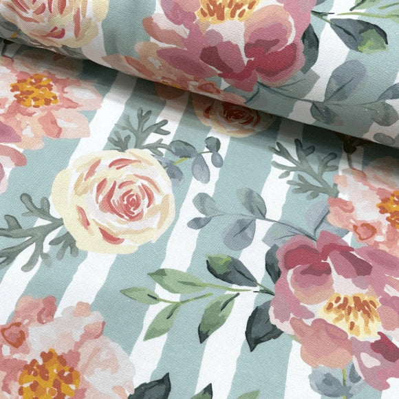Vintage pink roses and green leaves print upholstery fabric on a mint white stripe background.