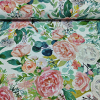 Watercolour floral patterned fabric with pink roses and green leaves on a white background.