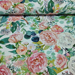 Watercolour floral patterned fabric with pink roses and green leaves on a white background.
