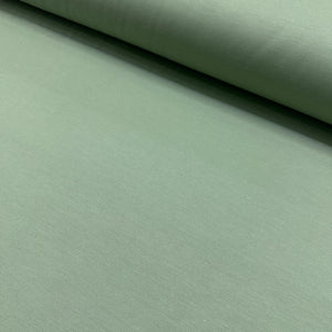 Sage green cotton canvas fabric with a plain woven texture, ideal for upholstery, curtains, cushions, bags, crafts, and soft furnishing projects.