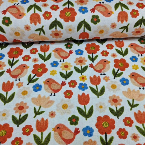 Scandi birds and flowers print upholstery curtain fabric in orange, green, yellow, blue and white.