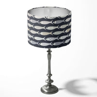 Navy blue table lampshade with grey fish-pattern on a white background.